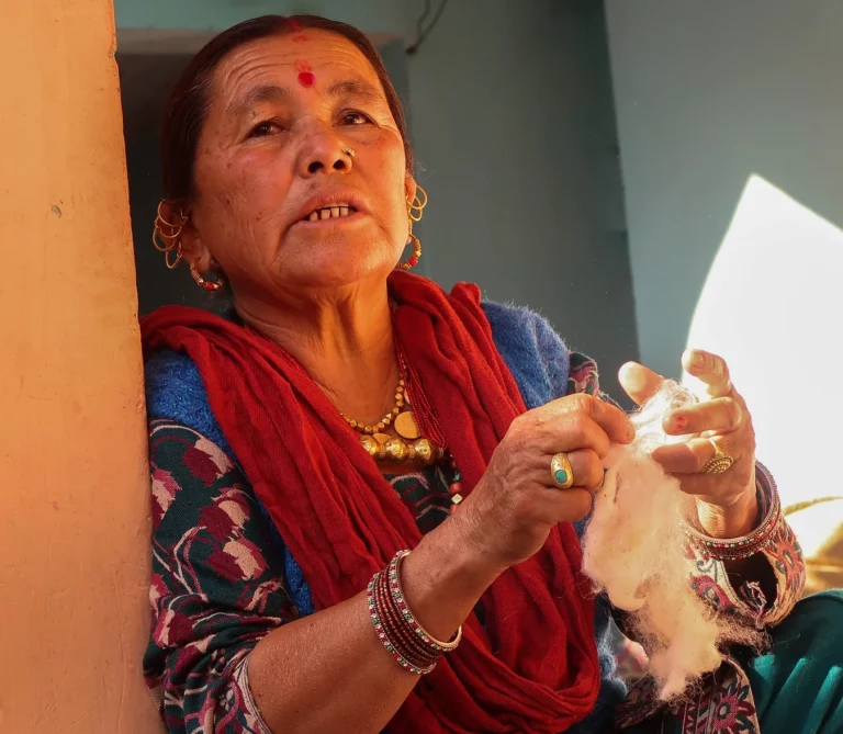 A Lady using Sheep wool for making Handmade Shawls stoles and scarves