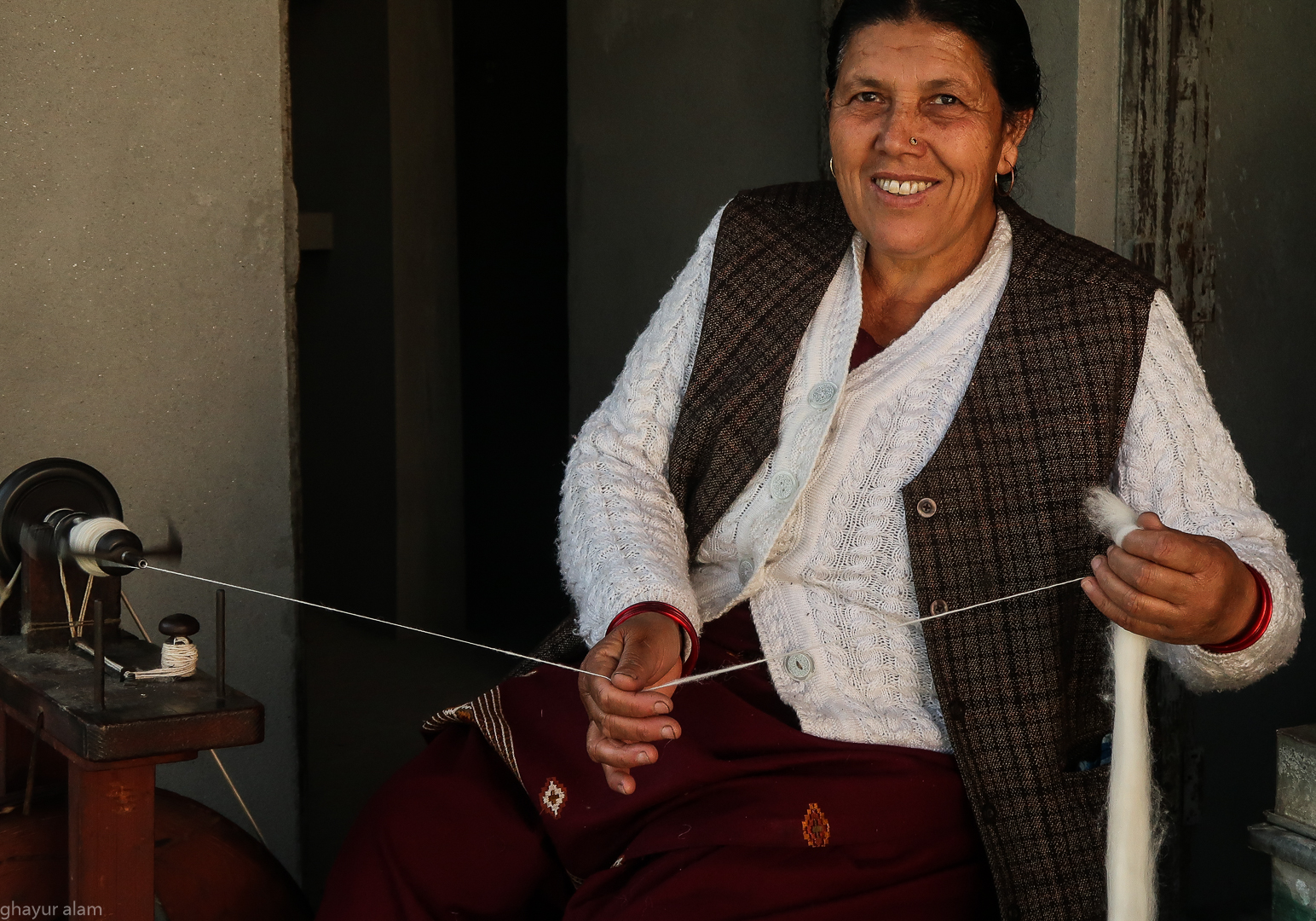 Hand spinning wool for making shawls in Dunda