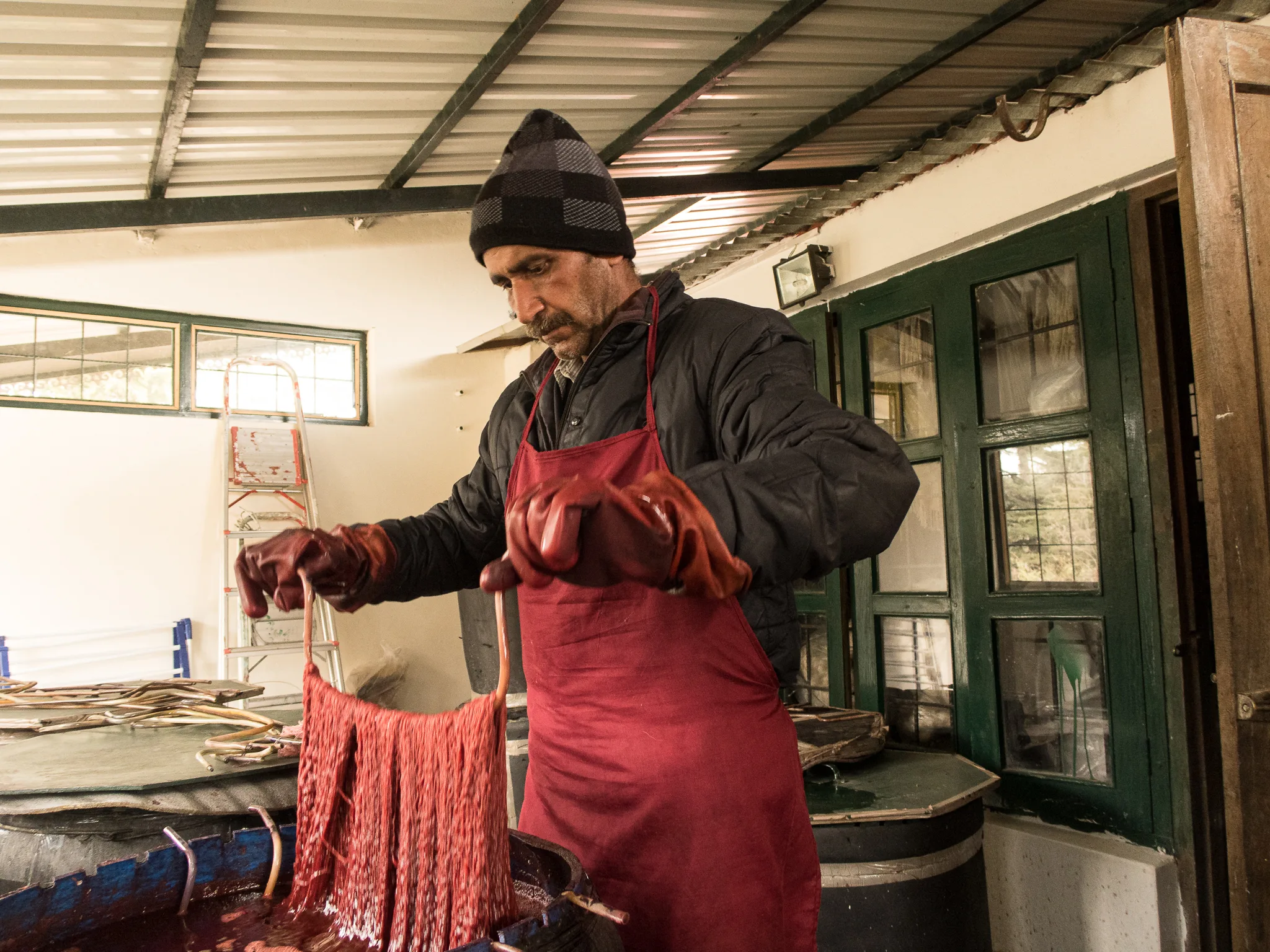 Makhan Prasad dyeing wool with Natural Dye Madder roots to make woollen stoles for Himalayan Weavers