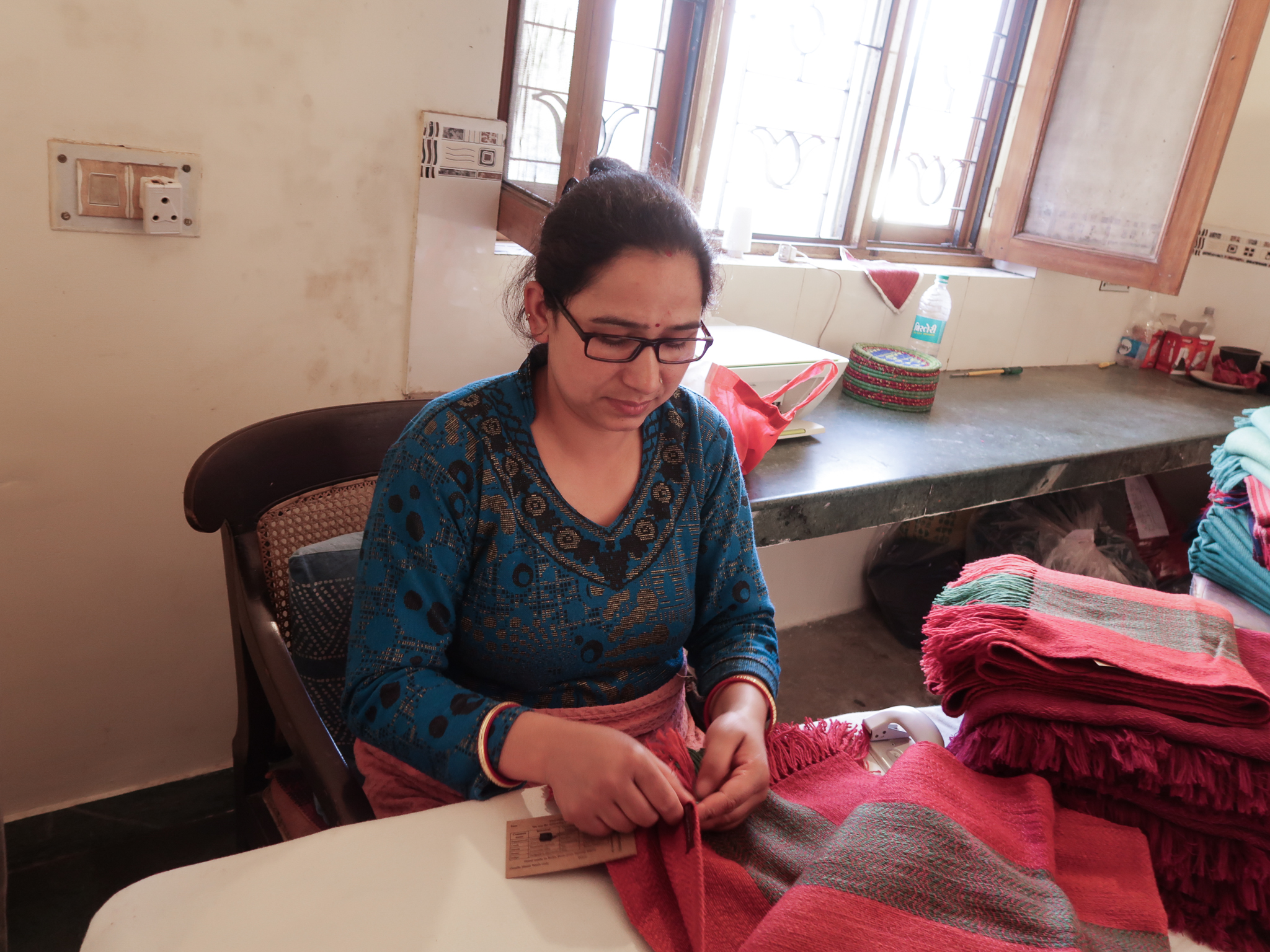 Hand-processing woollen scarves at Himalayan Weavers